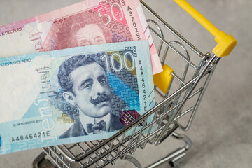 Empty shopping cart and Peruvian money, Concept, rising prices in stores, Shopping more expensive,...