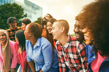 Naklejka premium Young diverse people having fun outdoor laughing together - Focus on bald girl face