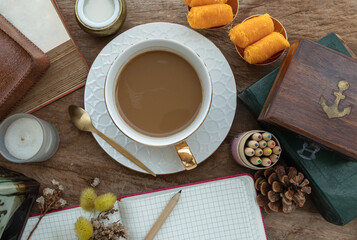 Hot coffee in ceramic cup and brass coffee spoon served with Fresh milk and Sweet egg floss (Foi...