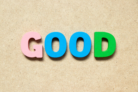 Color alphabet letter in word good on wood background