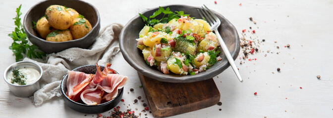 Kartoffelsalat - traditional German potato salad. Potato salad with bacon.