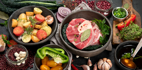 Metal spoon and food ingredients on dark background. Health cooking concept.