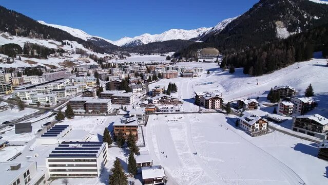Davos, Switzerland, aerial winter landscape. Residential area covered in snow , Swiss Alps.