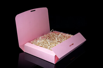 Blank package mockup. Pink paper box on black mirror background. Top view.