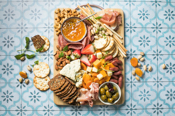 Antipasto meat board. catering platter with jamon, sausage and cheese. Food recipe background. Close up.