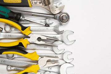 Fototapeta premium Set of tools for repair in a case on a white background. Assorted work or construction tools. Wrenches, Pliers, screwdriver. Top view