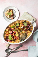Homemade bread pudding with jam on a pink  concrete background. Selective focus, copy space