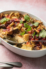 Homemade bread pudding with jam on a pink  concrete background. Selective focus, copy space
