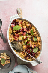 Homemade bread pudding with jam on a pink  concrete background. Selective focus, copy space
