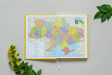 Top View of a Ukrainian map. Planning a trip or adventure. Travel planning dreams. Map of Ukraine. Travel, tourism and vacation concept background. Stylish notebook, map and magnifier. Flat lay.