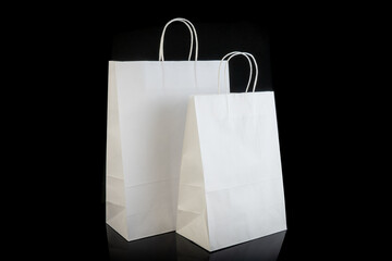 Set of paper bags for shopping on black background. Mockup for design