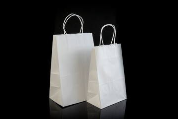 Set of paper bags for shopping on black background. Mockup for design