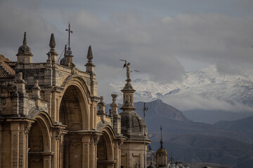 Granada Catedral (detail) with Sierra Nevada mountain range in the background. Andalusia, Spain.