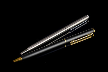 Ball pen duo silver and gold luxury. Two ball pens for signature in business solated on black...