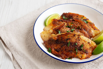 Homemade Pan Seared Tilapia on a Plate, side view.