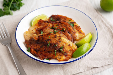 Homemade Pan Seared Tilapia on a Plate, side view.