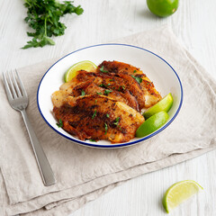 Homemade Pan Seared Tilapia on a Plate, side view.