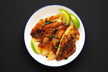 Homemade Pan Seared Tilapia on a Plate, top view. Flat lay, overhead, from above.