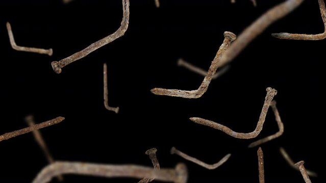 Animated loop of falling rusty nails on black