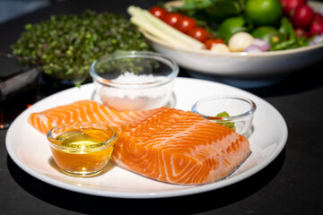 Salmon steak, Raw fillet of sea fish salmon or trout on white dish with salt, oil, and wasabi cream...