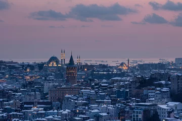 Fotobehang Galata tower in Istanbul, Turkey. Aerial view of landmark at golden hour with beautiful sunlight. Snow and winter season view in Istanbul. © mehmet
