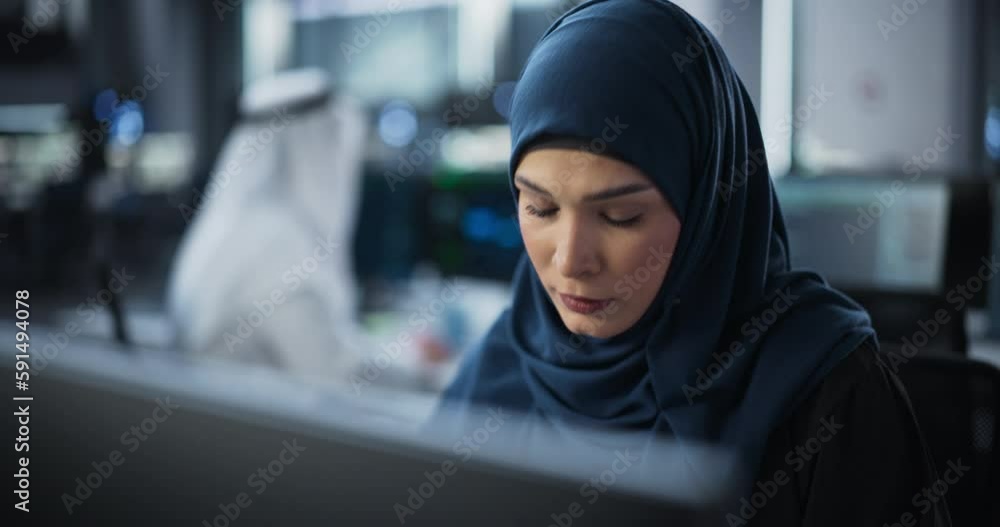Aufkleber Portrait of a Smart Focused Middle Eastern Engineer Working on Computer in a Technological Corporate Office. Young Arab Woman in Hijab Developing Software for an Innovative Internet Service Provider