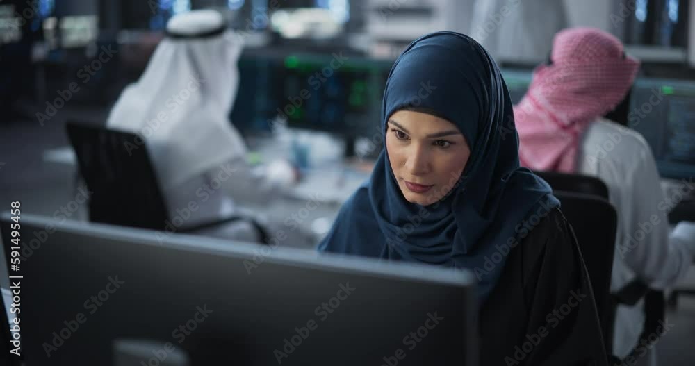 Aufkleber Portrait of a Smart Focused Middle Eastern Engineer Working on Computer in a Technological Corporate Office. Young Arab Woman Developing Software for an Innovative Internet Service Provider