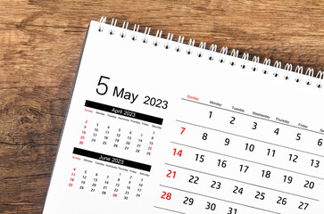 The May 2023 Monthly desk calendar for 2023 year on wooden background.