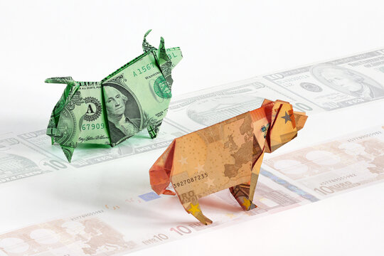 Running path currency competitions, dollar and euros in form of origami bull and bear