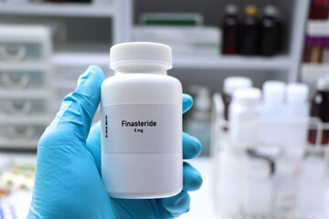 Finasteride pill in white bottle, pill stock