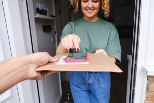 Smiling woman touching on device screen