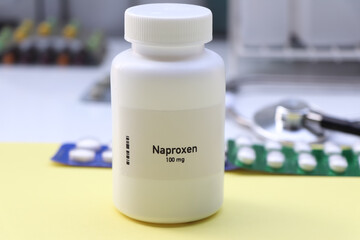 Naproxen pill in white bottle, pill stock
