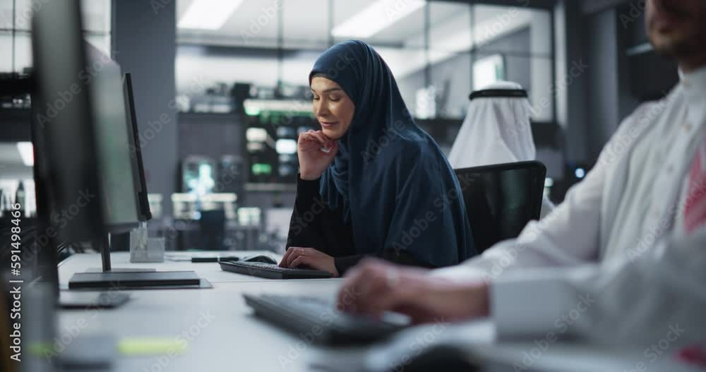 Leinwandbilder portrait of a thoughtful middle eastern female working on computer in a technological corporate offi