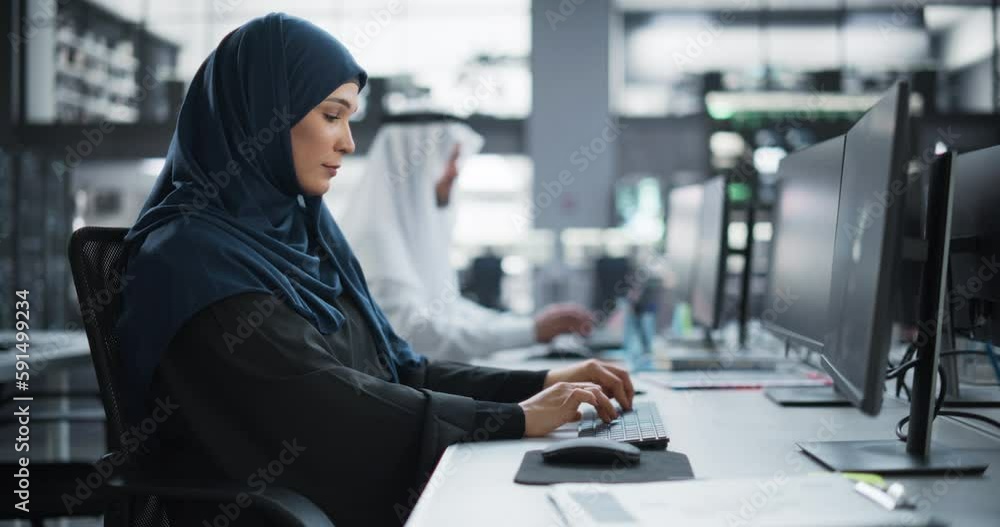 Aufkleber beautiful middle eastern computer scientist wearing a hijab, working on pc in a technological corpor