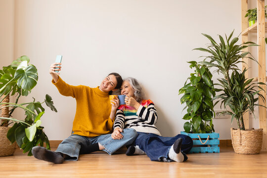 Happy Woman Taking Selfie And Toasting Coffee Cups At Home