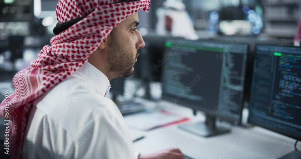 Poster smart young arab specialist working in a technological startup help desk department, using computer 