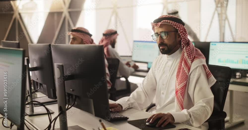 Aufkleber Portrait of a Middle Eastern Engineer Working on Desktop Computer in a Technological Office Environment. Arab Software Developer Researching New Ideas to Problem Solve a Technical Assignment