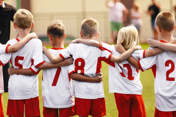 Children's soccer football team. Athletic boys teammates in junior soccer team united in team...