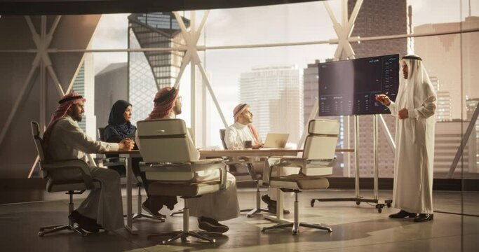 Muslim Businessman Holds Meeting Presentation for Diverse Business Partners. Manager Uses Digital Display with Growth Analytics, Charts, Statistics and Data. Saudi, Emirati, Arab Office Concept