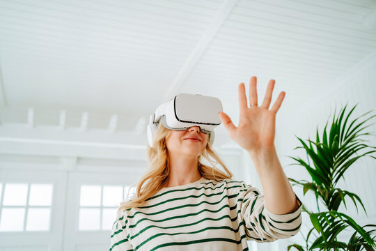 Woman playing virtual game at home