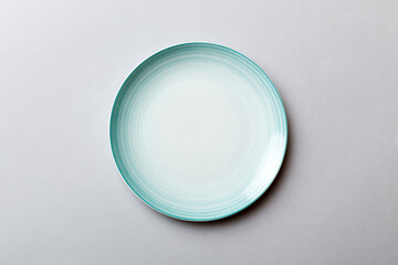 Top view of isolated of colored background empty round blue plate for food. Empty dish with space for your design