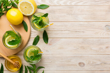 Caipirinha, Mojito cocktail, vodka or soda drink with lime, mint and straw on table background. Refreshing beverage with mint and lime in glass top view flat lay