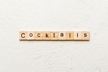 cocktails word written on wood block. cocktails text on cement table for your desing, concept