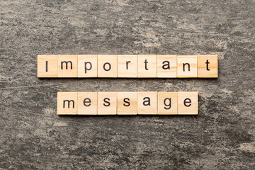 Important message word written on wood block. Important message text on cement table for your desing, Top view concept