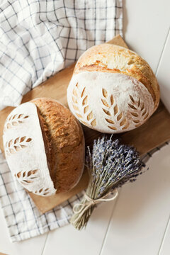 Freshly baked bread with dry lavender flowers on table