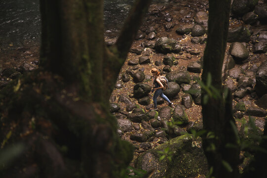 Woman with backpack walking in forest