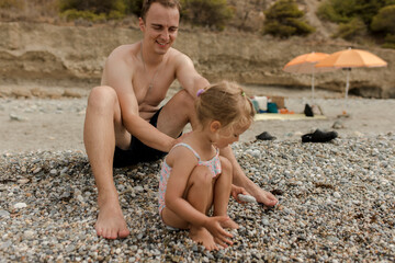 Father with daughter playing at beach