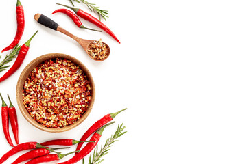 Red ripe chili pepper and spicy chili powder in bowl