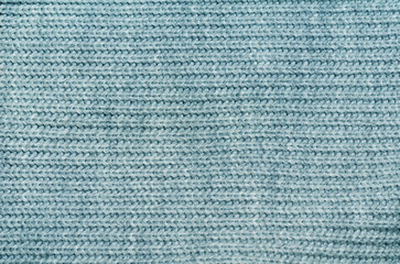 Gray knitted wool fabric sweater background top view