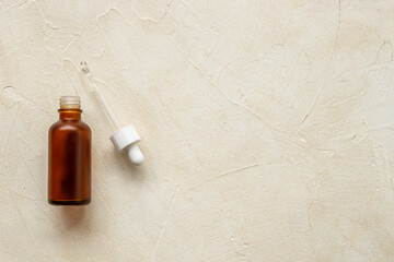 Face serum essential oil in dropper bottle top view